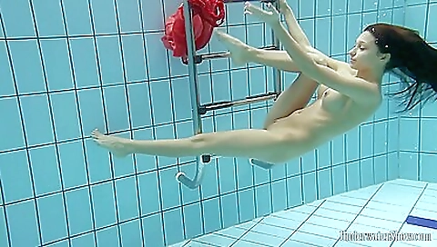 A brunette and redhead teen in the pool and shower
