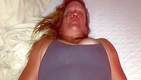 Mature woman in pink stockings enjoying hairy pussy