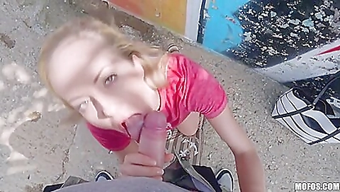 Slim blonde girl in a loose dress in an outdoor video