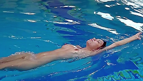 Sexy girl is naked and enjoys swimming in the pool