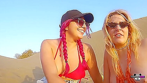 Beach threesome with two blonde women on the beach